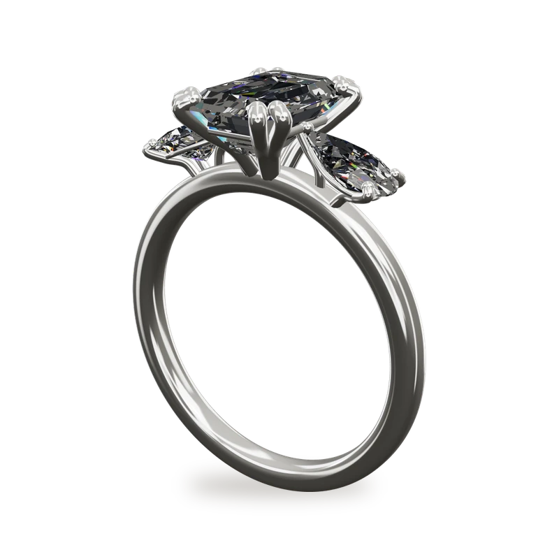 An emerald cut diamond engagement ring with pear shaped side stones in white gold