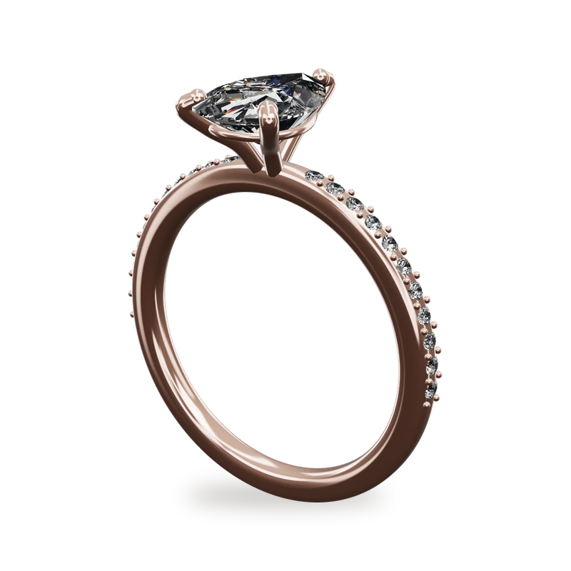 A lab-grown pear shaped diamond engagement ring with a pavé band in rose gold